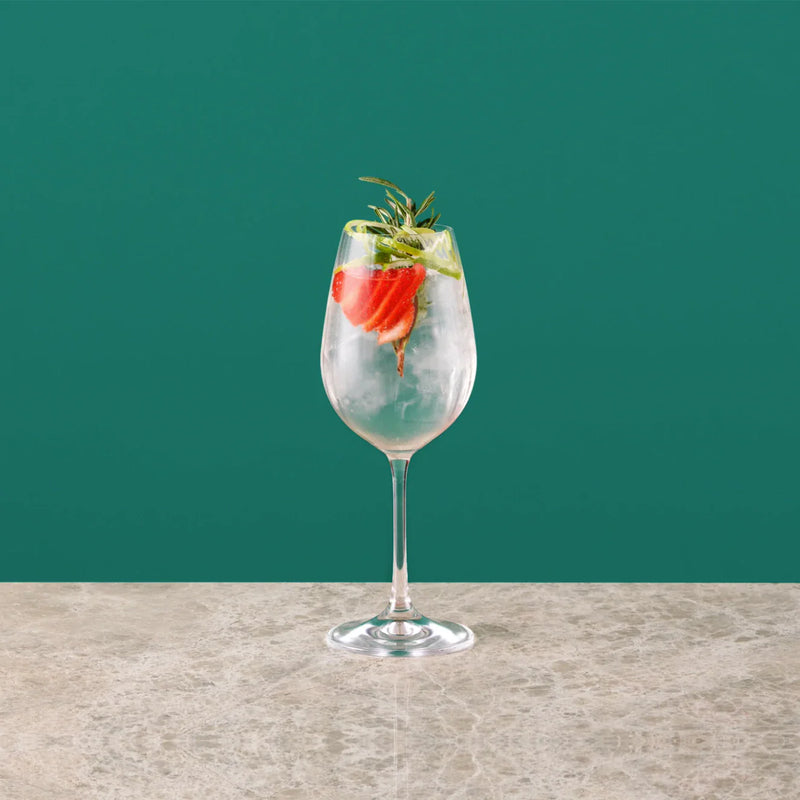 Strawberry Royal cocktail with sliced strawberries and fresh mint leaves in a glass.