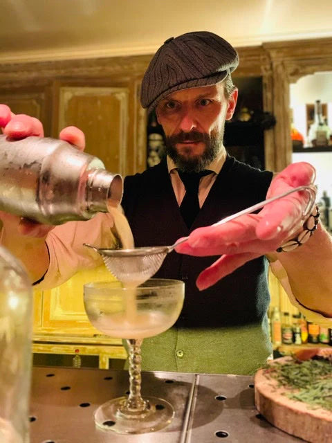 Welcomed by Sofie Ketels and Patrick: A skilled bartender pouring a cocktail with precision.