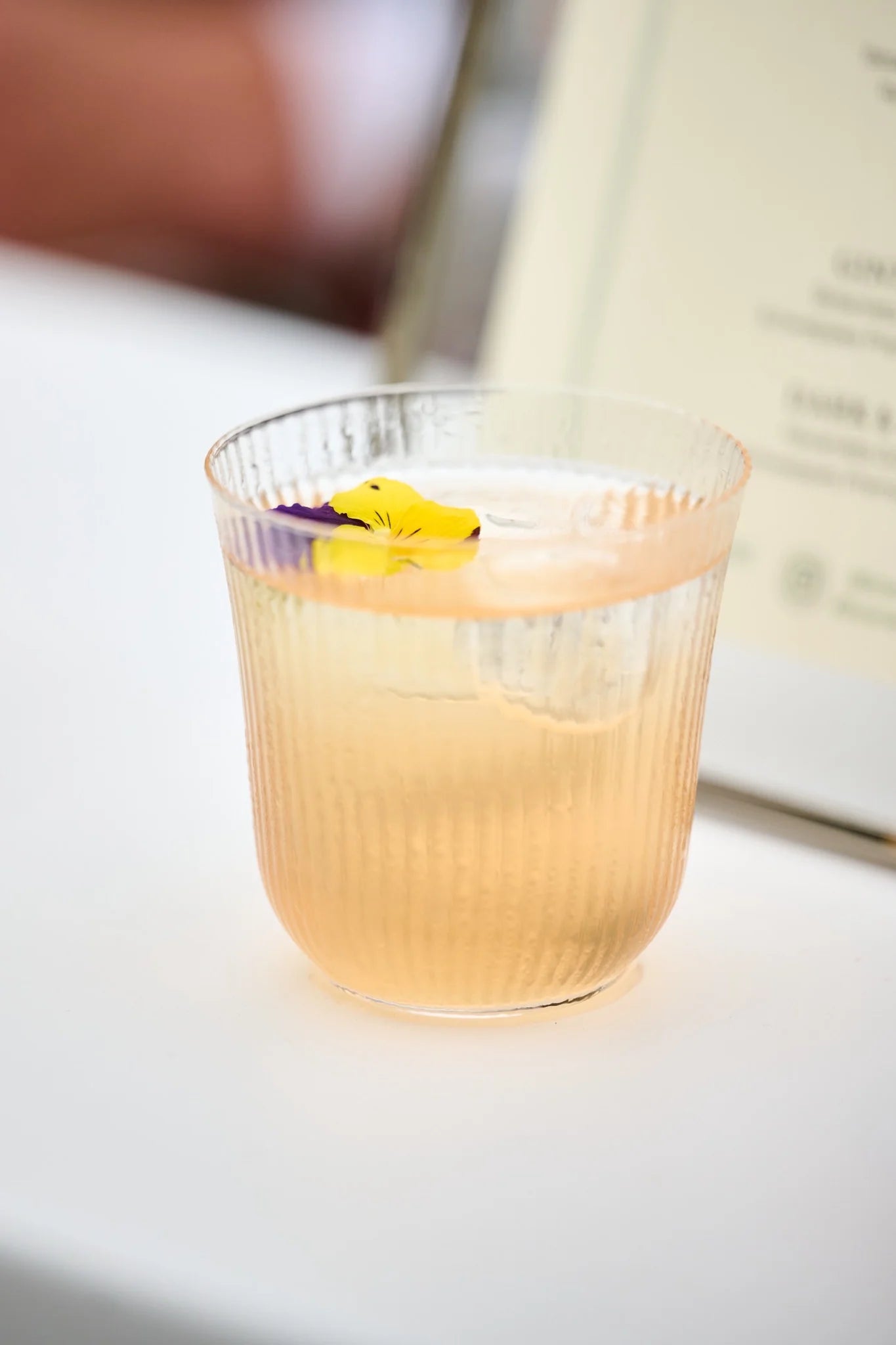 Enhance Your Mother's Day Mocktails with Edible Flower Garnishes in a beautifully presented drink.