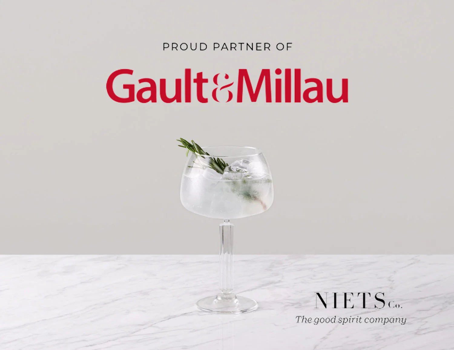 Niets official partner of Gault&Millau with a stylish cocktail on marble table.